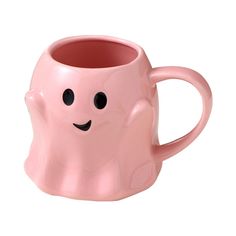 a pink mug with a smiley face on it