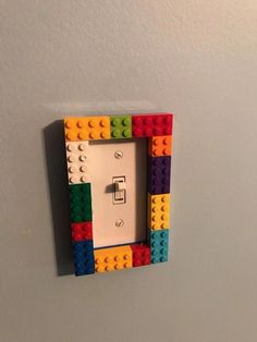 a light switch cover made out of legos on a white wall in a room