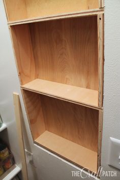 an unfinished bookcase is shown in the process of being built with plywood boards