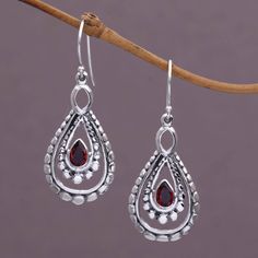 A pear-shaped garnet glistens at the heart of each of these dazzling dangle earrings. Using a combination of handmade and casting techniques artisan Nyoman Rena of Indonesia crafts the earrings from sterling silver. Pear-shaped Teardrop Earrings As Gift, Silver Gemstone Teardrop Earrings, Sterling Silver Gemstone Teardrop Earrings, Garnet Teardrop Jewelry With Matching Earrings, Teardrop Garnet For Jewelry Making, Teardrop Garnet Jewelry For Anniversary, Teardrop Garnet Silver Jewelry, Garnet Teardrop Earrings, Paw Print Jewelry