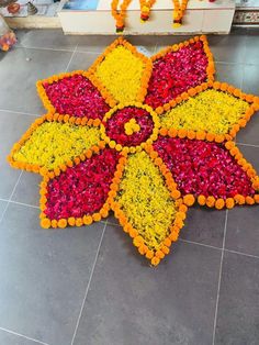 a large flower arrangement on the ground in front of a store