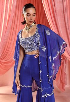 Command attention with this stunning ensemble: an embellished cape paired flawlessly with an embellished cami top and gharara bottoms. This combination of regal elegance and modern chic is perfect for making a statement at any event. Suits For Women Indian, Blue Cape, Trendy Dress Outfits, Sharara Set, Stylish Sarees, Stylish Dress Designs, Modern Chic, Indian Design, Trendy Dresses