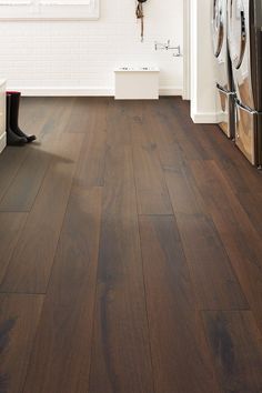 an image of a kitchen setting with wood flooring and washer in the background