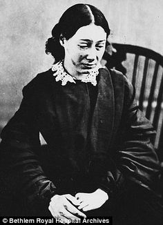 an old black and white photo of a woman sitting in a chair with her hands on her knees