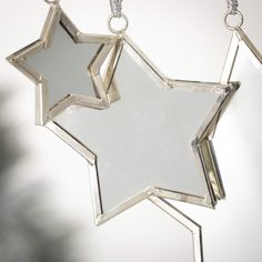 a star shaped mirror hanging from a chain