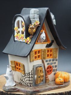 a halloween house with pumpkins and other decorations