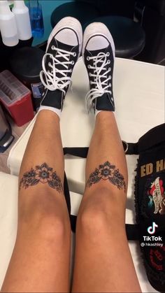 the legs and ankles of a woman with tattoos on her feet are seen in this screenshot