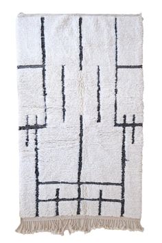 a white rug with black lines and fringes on the bottom, in front of a white background