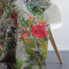 a chair with a flowered blanket on it