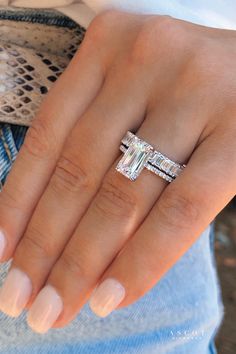 A magnificent engagement ring. Showcasing a perfect emerald cut diamond, set in a thin delicate diamond band solitaire ring, next to a custom emerald cut diamond eternity band. Emerald Diamond Engagement Ring With Wedding Band, Rectangle Wedding Ring Stack, Emerald Engagement Ring Pave Band, Emerald Ring With Band, Rectangle Engagement Ring With Diamond Band, Wedding Bands That Go With Emerald Cut, Rectangle Ring With Wedding Band, Wedding Band Emerald Engagement Ring, Emerald Ring Wedding Band