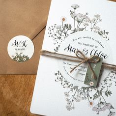 the wedding stationery is tied with twine and has a tag that says, mr and mrs