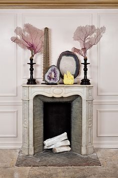 a white fireplace with decorative items on top