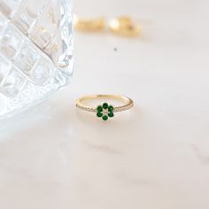 The vibrancy of this emerald flower ring is breathtaking! Emerald represents so many great qualities and is an essential piece in your jewelry collection! This flower ring pairs the beauty of nature just perfectly! The emerald stones are a beautiful vibrant color and it's set against radiant and brilliant cubic zirconia stones that shine so bright. This ring is minimalist and dainty, and great for stacking or worn alone. Makes a great gift to yourself or someone special! At Sami Jewels, we belie Chunky Earrings, Celestial Jewelry, Stacked Jewelry, Initial Jewelry, Statement Bracelet, Timeless Jewelry, Sapphire Jewelry, Anklet Jewelry, Flower Ring