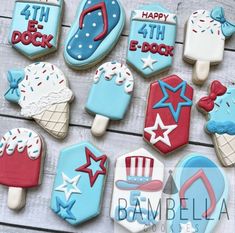 decorated cookies are arranged on a table for the fourth of july day celebration, including ice cream and popsicles