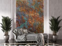 a living room with a couch and two potted plants in front of a large painting