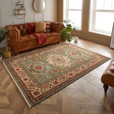 a living room with a couch, chair and rug