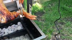 a person is cooking meat on an outdoor grill