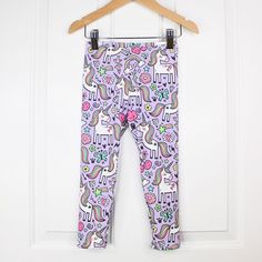 Purple unicorn print leggings handmade to order in your selected size. Great for play with an elastic waistband to keep them snug. These colors and fabric will hold up excellently wash after wash and will continue to look great and hold their shape!  Highly detailed and color-rich design. Please message me with any questions or custom requests! I'm happy to help. Also available in a pink colorway and shorts in my shop.  Colors: purple, pink, teal, white, black Fabric Content: 95% polyester, 5% s Playful Footless Bottoms For Playwear, Playful Footless Playwear Bottoms, Cute Stretch Leggings For Playwear, Playful Purple Bottoms For Playtime, Playful Multicolor Cotton Leggings, Unicorn Print Cotton Sleepwear For Loungewear, Leggings For Girls, Girls Back, Whimsical Unicorn Print Dress For Dress-up