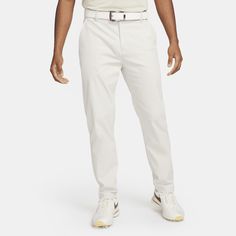 From the range to the course to the clubhouse, the Nike Tour chino pants provide a clean look and comfortable fit you can wear just about anywhere. They're designed to let you feel confident through each swing thanks to their relaxed-yet-streamlined fit and stretchy, sweat-wicking fabric. Got a scorecard, yardage book and tees? There's plenty of pockets for your essentials to make it through all 18. White Cotton Golf Bottoms, Sporty White Bottoms For Golf, Casual Nike Golf Bottoms, Golf Essentials, Golf Pants, Mens Chinos, Chino Pants, Make It Through, Chinos Pants