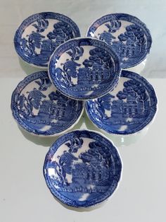 six blue and white plates with designs on them