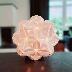 a white origami light sitting on top of a table