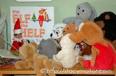 several stuffed animals sitting on a shelf in front of a children's bookcase