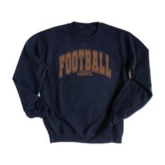 Looking for a cute versatile top to wear this summer? Make sure to grab one of our Varsity Football Vibes Sweatshirts! This soft and comfortable shirt is the perfect top for any outfit. It can be paired with biker shorts, Jeans, or the classic stay at home sweats! The bright color adds a pop of summer to any outfit. This sweatshirt is true-to-size, so be sure to order your regular size! If you are looking for a more oversized look, make sure to size up. Navy Crew Neck Fan Apparel Top, Navy Collegiate Crew Neck Top, Graphic Tee For Game Day And Fall, Collegiate Screen Print Tops For Fall, Team Spirit Graphic Print Tops For Fall, Navy Casual Top With Team Name, Navy Cotton Varsity Top, Varsity Style Relaxed Fit Top For Fall, Relaxed Fit Tops For College In Fall