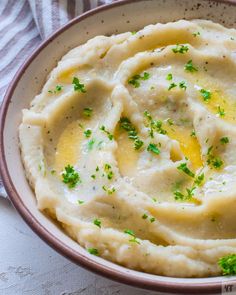 mashed potatoes topped with parsley in a bowl