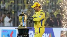 a man in yellow uniform holding a trophy