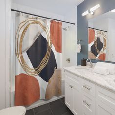 a bathroom with a shower curtain that has an abstract design on it, along with a toilet and sink