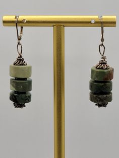 These are gorgeous handmade green gemstone earrings.  ATTRIBUTES - Marked 925 sterling leverback hooks for pierced ears - Artisan handmade  - We believe this is green jasper based off research, but we are not gemologists - Stones are cold to the touch - Stacked round green stones with sterling findings  - Beautiful condition with minor wear from gentle use MEASUREMENTS - 1.90" long x 0.47" wide CONDITION - Excellent GENTLY USED condition with minor wear MORE BEAUTIFUL EARRINGS - https://www.etsy.com/shop/SiftedandRefined?section_id=32269566 BACK TO OUR STOREFRONT - https://www.etsy.com/shop/SiftedandRefined SPECIAL NOTE - Props such as trays, display stands, jewelry boxes, rulers, or coins are not included SHIPPING - We package items in organza or velvet gift bags - included FREE - Orders Adjustable Jade Jewelry With Ear Wire, Adjustable Jade Earrings With Ear Wire, Nickel-free Green Jade Jewelry, Nickel-free Green Jewelry In Sterling Silver, Nickel-free Green Sterling Silver Jewelry, Green Artisan Dangle Jewelry, Artisan Green Dangle Jewelry, Artisan Green Jade Jewelry, Green Sterling Silver Dangle Jewelry