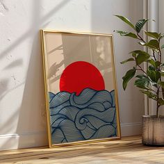 an art print on the wall next to a plant and potted plant in front of it