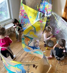 several children are playing with an art project