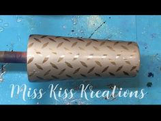 a roll of brown paper sitting on top of a blue surface with words miss kiss keratins