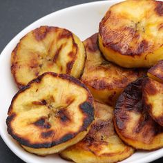 a white plate topped with sliced bananas on top of a table