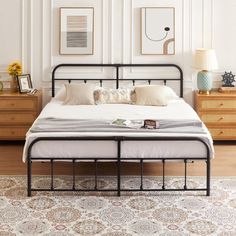 a bed sitting on top of a wooden floor in a bedroom