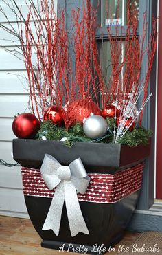 an image of a planter with christmas decorations in it on the front door sill