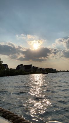 the sun shines brightly through clouds over water