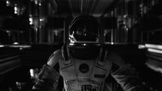 an astronaut is standing in the dark with his helmet on