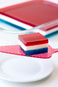 a red, white and blue dessert sitting on top of a plate