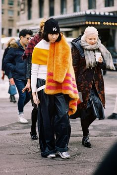 If you're going to wear a loose silhouette with your sneakers and beanie, add a pop of color with a fluffy coat or scarf like Susie Lau of Style Bubble. // License To Chill: The Comfy Weekend Combo To Try Chill Fashion, Orange Scarf, Fluffy Coat, White Turtleneck, Weather Wear, Tokyo Fashion, Fashion Gallery