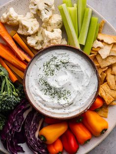 a white plate topped with veggies and dip