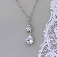 "Annie silver tone crystal bridal necklace has been designed by us to match our popular Annie earrings. A beautiful teardrop sits beneath a marquise crystal cluster all in white gold, for an elegant and classy bridal necklace. Length-16.5\" chain plus 1.5\" extender (optional) Crystal zircons set in a tarnish free rhodium base. (aka white gold) 💜 Available in rose gold, silver (rhodium) 💟 Items that coordinate or are frequently bought together (such as in photos/collages): Bracelets: https://w Dazzling White Gold Drop Necklace For Wedding, White Gold Cubic Zirconia Drop Necklace For Wedding, White Gold Diamond Cut Drop Necklace For Wedding, Sparkling Dangle Necklaces For Wedding, Sparkling Dangle Necklace For Wedding, Wedding Teardrop Pendant Necklace With Diamond Cut, Sterling Silver Drop Necklace For Wedding, White Gold Drop Bridal Necklace With Cubic Zirconia, White Gold Cubic Zirconia Drop Bridal Necklace