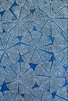 a blue and white painting with lots of dots on it