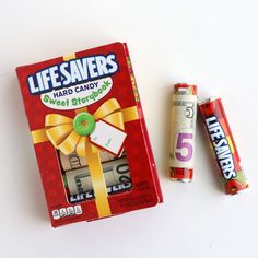 a box of candy and two batteries on a white surface with the words lifesaverss next to it