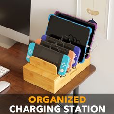 an organized charging station for nintendo wii game console controllers and games on a wooden desk