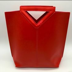 New Kenzo Red Poly Faux Leather Handbag Tote Bag. Easy To Clean Material. Size: 14.5 L4.5 W Brand New In Sealed Bag. Designer Red Rectangular Bucket Bag, Trendy Red Top Handle Bucket Bag, Modern Red Bag With Removable Pouch, Red Bucket Bag With Top Carry Handle, Red Double Handle Bucket Bag With Top Carry, Red Bucket Bag With Top Carry Handle For Shopping, Red Satchel Bucket Bag With Top Carry Handle, Modern Red Bucket Bag With Detachable Handle, Red Tote Bucket Bag With Top Carry Handle