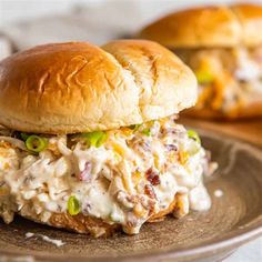 two chicken salad sandwiches sitting on top of a plate