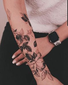 a woman's arm with flowers on it