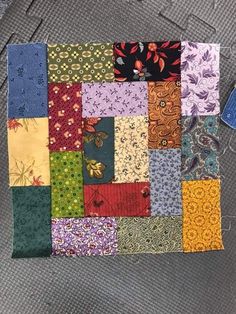 a patchwork quilt with many different colors and patterns on the front, side, and back